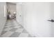 Inviting hallway featuring gray and white checkerboard floors and white walls at 2718 N 21St St, Tampa, FL 33605