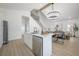 Island kitchen offers stainless appliances, marble counters, and a view of the open concept living space at 2718 N 21St St, Tampa, FL 33605