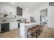 Modern kitchen with white cabinetry, marble countertops, and a stylish island with seating at 2718 N 21St St, Tampa, FL 33605
