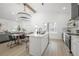 Open concept kitchen with bright lighting, marble island, stainless appliances, dining, and living area at 2718 N 21St St, Tampa, FL 33605