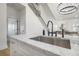 Kitchen offers stainless steel appliances, marble counters, and a view of the open concept living space at 2718 N 21St St, Tampa, FL 33605