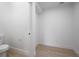 Modern, minimalist toilet room with light wood flooring and clean white walls, awaiting personalization at 2718 N 21St St, Tampa, FL 33605