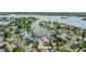 Expansive aerial view showcasing waterfront property with lush landscaping and boat access to the bay at 300 10Th Ave, Indian Rocks Beach, FL 33785
