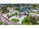 Aerial view of a waterfront property with lush landscaping, multiple pools, and neighboring canal homes at 300 10Th Ave, Indian Rocks Beach, FL 33785