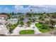 An aerial view of the home and its surroundings showcasing lush landscaping and waterways at 300 10Th Ave, Indian Rocks Beach, FL 33785