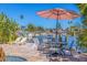 Waterfront backyard patio with outdoor dining area, lounge chairs, and tropical landscaping at 300 10Th Ave, Indian Rocks Beach, FL 33785