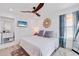 Bright bedroom boasts white walls, a ceiling fan, and a flat screen TV with beach scene displayed on the screen at 300 10Th Ave, Indian Rocks Beach, FL 33785