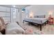 Inviting bedroom featuring a comfortable lounge area, wood flooring, beach scene on TV, and bright decor at 300 10Th Ave, Indian Rocks Beach, FL 33785