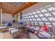 Inviting covered patio with comfortable wicker furniture and stylish outdoor decor at 300 10Th Ave, Indian Rocks Beach, FL 33785
