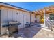 Exterior view of a patio area featuring a grill and outdoor seating with a bright yellow door at 300 10Th Ave, Indian Rocks Beach, FL 33785