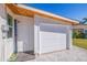 Exterior of a home featuring a garage, an outdoor shower, and paver driveway at 300 10Th Ave, Indian Rocks Beach, FL 33785