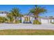 A charming home with a well-manicured lawn and a paver driveway at 300 10Th Ave, Indian Rocks Beach, FL 33785