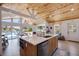 Kitchen featuring a large island with seating, modern appliances, and a view of the living area and waterfront at 300 10Th Ave, Indian Rocks Beach, FL 33785