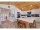 Spacious kitchen featuring a large island with seating, stainless steel appliances, and wood-paneled vaulted ceilings at 300 10Th Ave, Indian Rocks Beach, FL 33785
