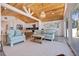 Open-concept living room showcasing wood ceilings, beachy decor, and seamless flow to the kitchen at 300 10Th Ave, Indian Rocks Beach, FL 33785