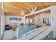 Spacious living area with wood ceiling, open to the kitchen, and decorated in a beachy style at 300 10Th Ave, Indian Rocks Beach, FL 33785