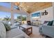 Cozy living room with wood ceiling, relaxed seating, and a view of the outdoor pool and waterfront at 300 10Th Ave, Indian Rocks Beach, FL 33785