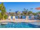 An inviting pool area with waterfront views, lounge chairs, and a small dock at 300 10Th Ave, Indian Rocks Beach, FL 33785