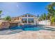 Stunning pool area with rock waterfall feature, lush landscaping, and an outdoor living space at 300 10Th Ave, Indian Rocks Beach, FL 33785