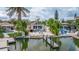An attractive home featuring a dock, pools, and outdoor lounge areas at 300 10Th Ave, Indian Rocks Beach, FL 33785
