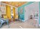 Bright sitting area with yellow curtains, colorful walls, and comfortable seating at 300 10Th Ave, Indian Rocks Beach, FL 33785