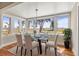 Bright dining room features water views from ample windows and a glass-top table for elegant meals at 308 Chauncey Ave, Bradenton, FL 34208