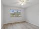 Bright bedroom with a ceiling fan, new flooring and a window overlooking the outdoors at 314 Barlow Ave # 73, Sarasota, FL 34232