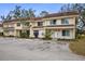 Inviting exterior view of a two-story townhome featuring an open parking area and a well-maintained lawn at 314 Barlow Ave # 73, Sarasota, FL 34232