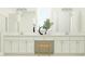 Bright bathroom with dual vanity, white cabinetry, and stylish decor accents at 31670 Cannon Rush Dr, San Antonio, FL 33576