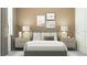 This staged bedroom features two bedside tables, neutral tones and beach themed wall art at 31670 Cannon Rush Dr, San Antonio, FL 33576