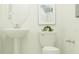 Contemporary powder room with pedestal sink, modern toilet, and stylish accents at 31670 Cannon Rush Dr, San Antonio, FL 33576