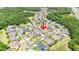 Aerial view of neighborhood showcasing a home with mature trees and landscaping near winding streets at 3227 Watermark Dr, Wesley Chapel, FL 33544