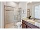 Bathroom with granite countertop vanity and tiled walk-in shower at 3227 Watermark Dr, Wesley Chapel, FL 33544