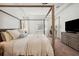 Spacious bedroom features a four-poster bed, neutral tones, and windows at 3227 Watermark Dr, Wesley Chapel, FL 33544