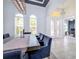 Spacious dining room showcasing high ceilings, large windows, and easy access to the main entrance and kitchen at 3227 Watermark Dr, Wesley Chapel, FL 33544