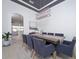 Elegant dining room featuring modern lighting, a large table, and seating for eight, perfect for entertaining at 3227 Watermark Dr, Wesley Chapel, FL 33544