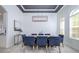 Bright dining area with stylish chandelier, tray ceiling, and large window providing plenty of natural light at 3227 Watermark Dr, Wesley Chapel, FL 33544