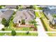 Aerial view of home featuring well-manicured landscaping, a large driveway, and a welcoming front entrance at 3227 Watermark Dr, Wesley Chapel, FL 33544
