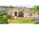 Charming home with a well-maintained lawn, landscaped beds, and mature palm trees at 3227 Watermark Dr, Wesley Chapel, FL 33544