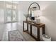 Bright foyer featuring tile flooring, high ceilings, and an ornate front door at 3227 Watermark Dr, Wesley Chapel, FL 33544