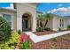 Inviting entryway with a walkway leading to a glass-paned front door at 3227 Watermark Dr, Wesley Chapel, FL 33544