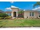 Inviting facade featuring manicured lawn, mulch beds and attractive landscaping at 3227 Watermark Dr, Wesley Chapel, FL 33544