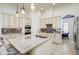 Gourmet kitchen with a spacious island, stainless appliances, tile backsplash, and views into the adjacent dining area at 3227 Watermark Dr, Wesley Chapel, FL 33544
