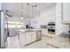 Open kitchen with stainless steel appliances, granite countertops, a large island, and modern pendant lighting at 3227 Watermark Dr, Wesley Chapel, FL 33544