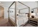 Bright main bedroom featuring a beautiful canopy bed and neutral decor with lots of natural light at 3227 Watermark Dr, Wesley Chapel, FL 33544
