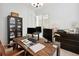 Bright home office featuring a modern desk, display shelving, and ample workspace at 3227 Watermark Dr, Wesley Chapel, FL 33544