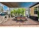 Covered outdoor dining area with grill, kitchen, and shade at 3227 Watermark Dr, Wesley Chapel, FL 33544