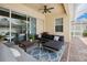Covered patio with comfortable seating and ceiling fans, perfect for outdoor relaxation and entertaining at 3227 Watermark Dr, Wesley Chapel, FL 33544