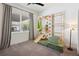 Bright playroom features climbing wall, soft mat flooring, and natural light from the nearby window, ideal for  at 3227 Watermark Dr, Wesley Chapel, FL 33544