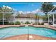 Screened-in swimming pool with seating area, brick coping, and serene backdrop at 3227 Watermark Dr, Wesley Chapel, FL 33544